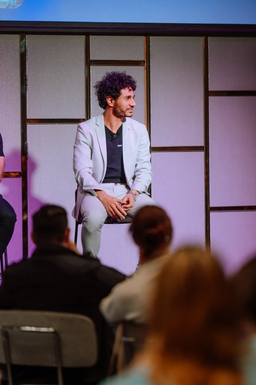 Abdo Samy seated on stage during a fireside session at the AI Bootcamp